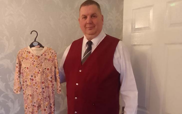 Craig Greenwood holding children's pjs from donations given to Kind-hearted West Yorkshire.